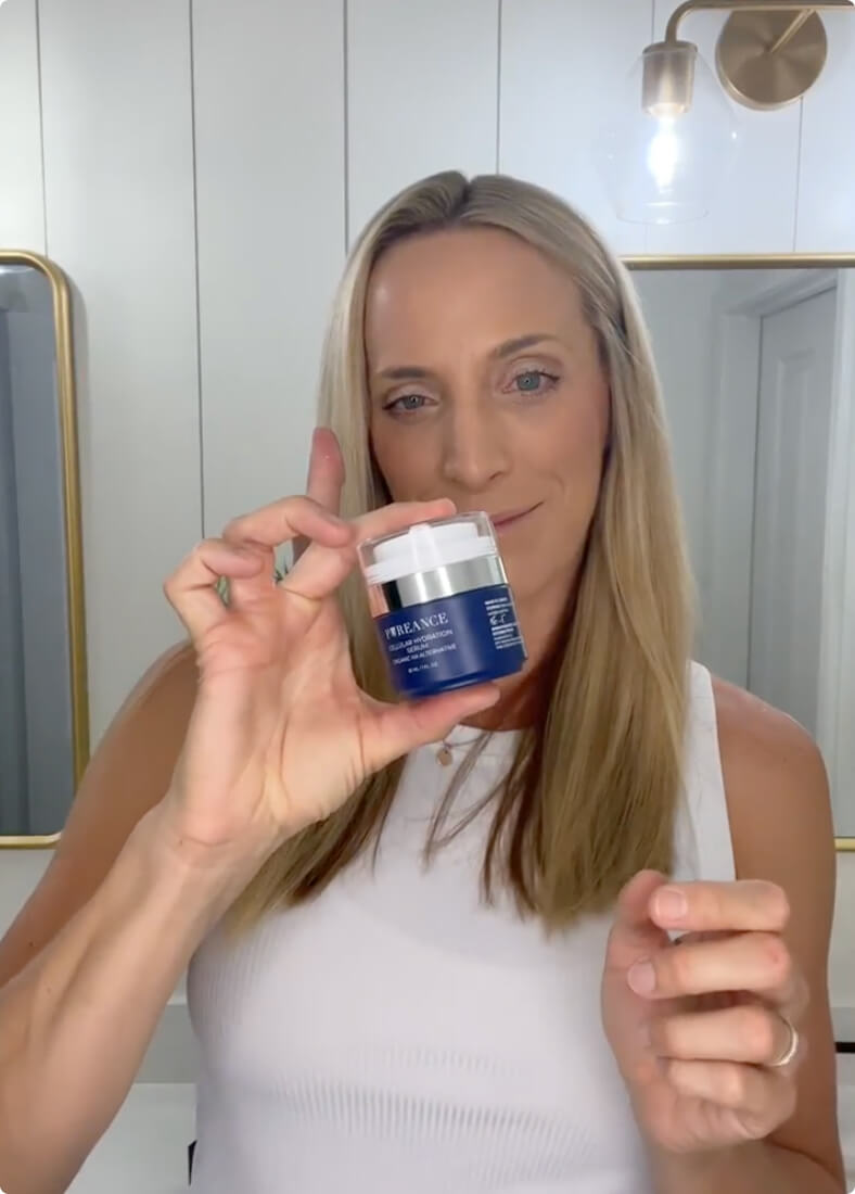 A woman with long blonde hair in a white top holds a jar of Pureance Cellular Hydration Serum.